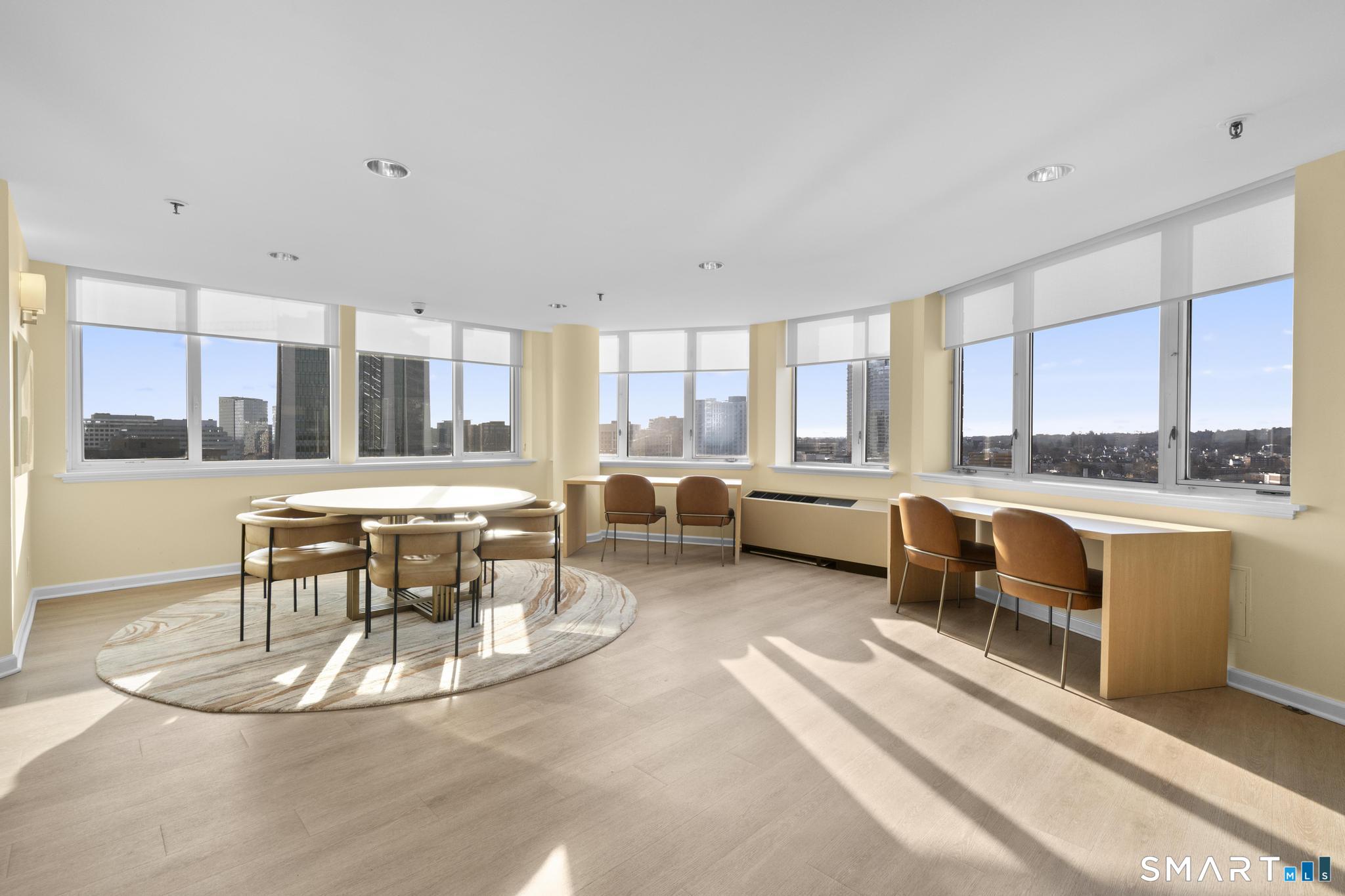 25 Forest Street, Unit 15E Stamford, CT 06901 - Photo 31 of 40 a living room with furniture and a large window