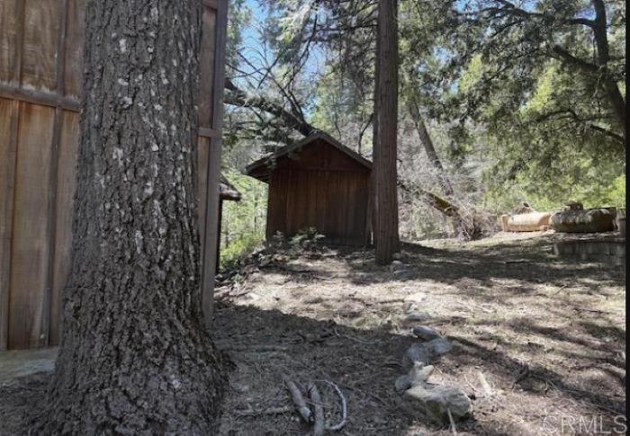 22021 Crestline Road Palomar Mountain, CA 92060 - Photo 8 of 15 a view of a house with a tree in the yard