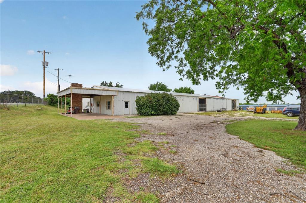 1092 West Highway 199 Springtown, TX 76082 - Photo 4 of 29 Expansive metal building with carport and multiple exterior doors