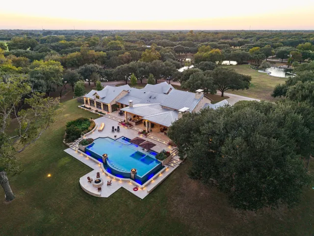 an aerial view of residential house with outdoor space and river view