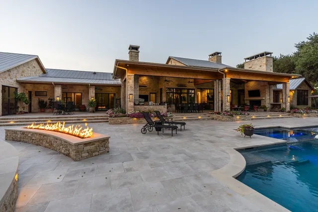 a living room with furniture a flat screen tv and floor to ceiling window