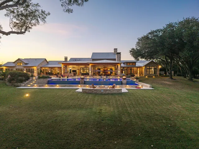 a living room with furniture a flat screen tv and a large window