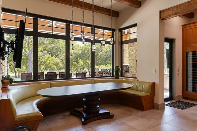 a view of a dining room with furniture large windows and wooden floor
