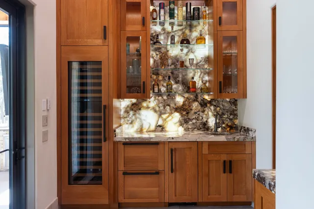 a hallway with a large mirror and a sink