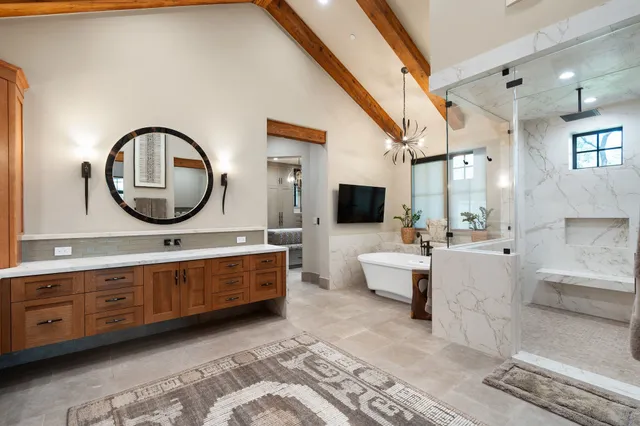 a bedroom with a bed and a large window