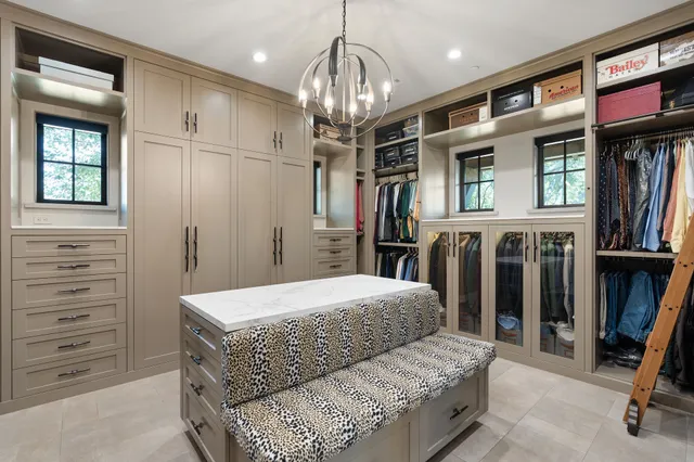 a bedroom with a bed a couch and large window