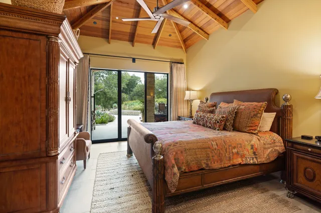 a bathroom with a granite countertop toilet sink and mirror