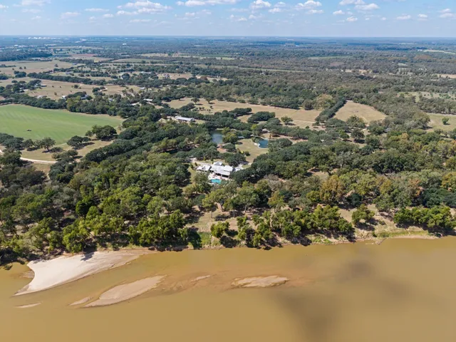 an aerial view of a houses with a lake view