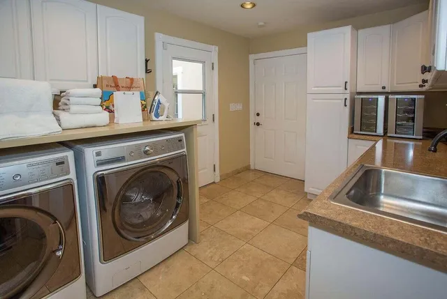 a utility room with sink dryer and washer