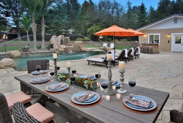 a view of a patio with furniture and backyard
