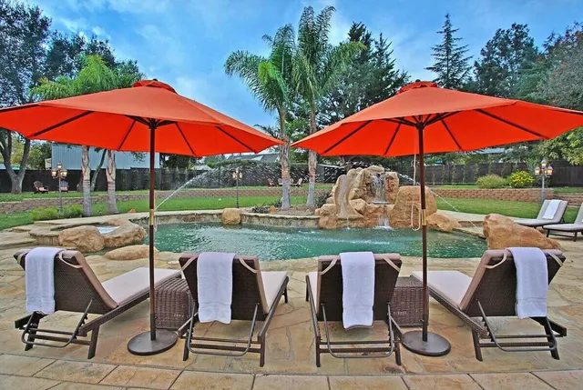an outdoor space with furniture and umbrella