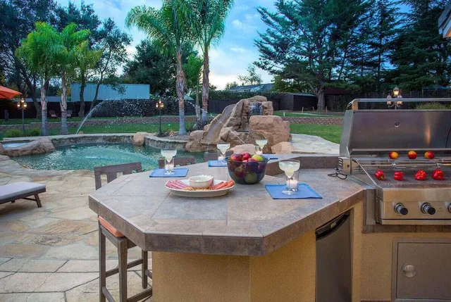 a view of backyard and kitchen with seating space