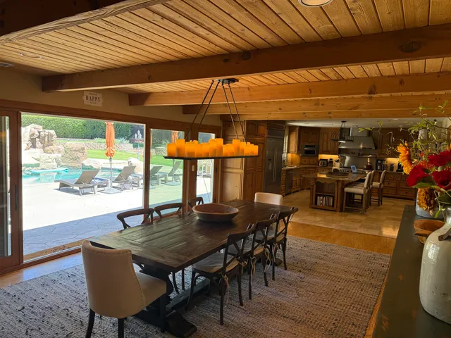 a dining room with furniture and wooden floor