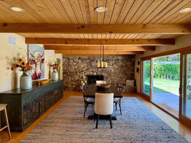a dining room with furniture a rug and wooden floor
