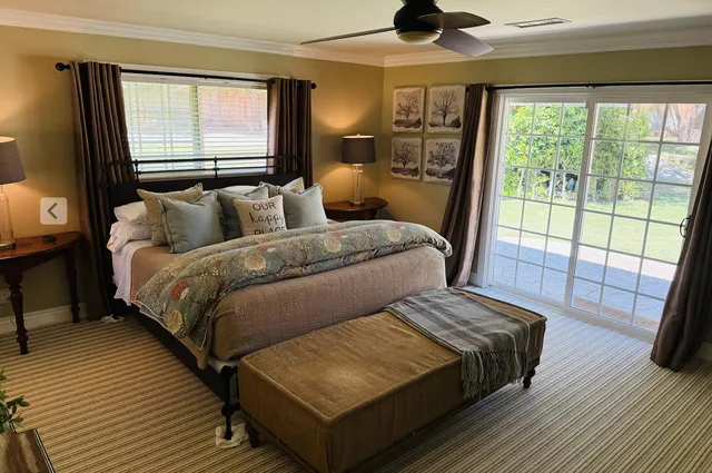 a bedroom with double bed and a window