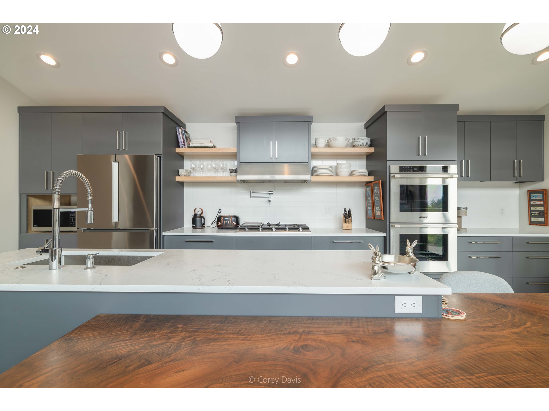 8760 Mariners Nehalem, OR 97131 - Photo 14 of 40 a kitchen with kitchen island stainless steel appliances a sink a stove and a refrigerator