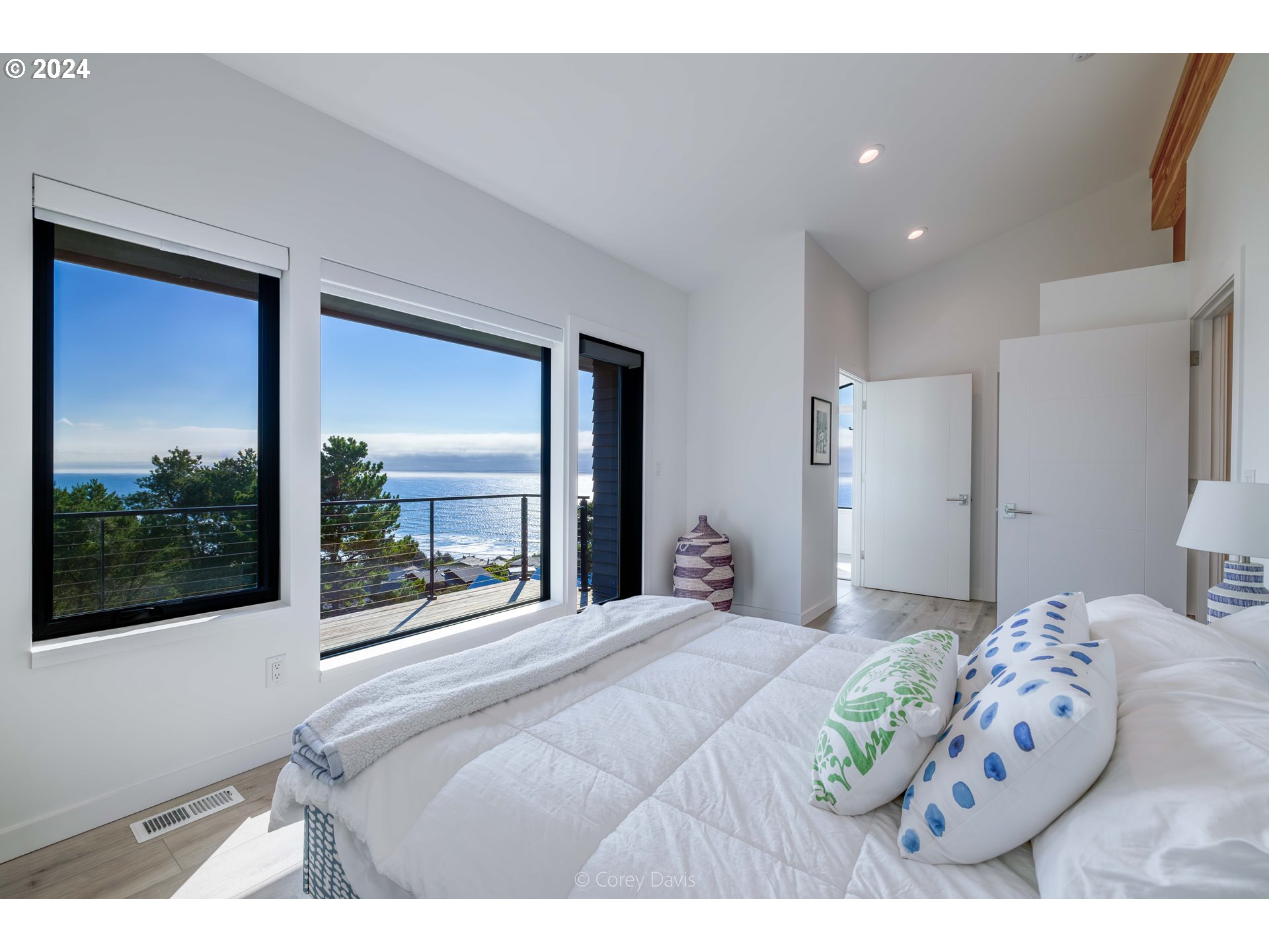 8760 Mariners Nehalem, OR 97131 - Photo 18 of 40 a bedroom with a large bed and a large window