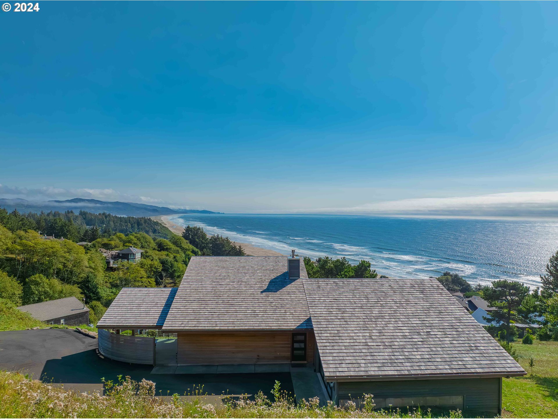 8760 Mariners Nehalem, OR 97131 - Photo 2 of 40 an aerial view of a house with a yard and lake view
