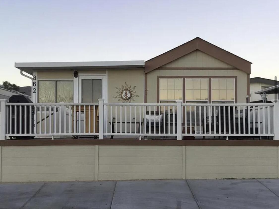 74711 Dillon Road Desert Hot Springs, CA 92241 - Photo 3 of 41 front view of a house with a fence