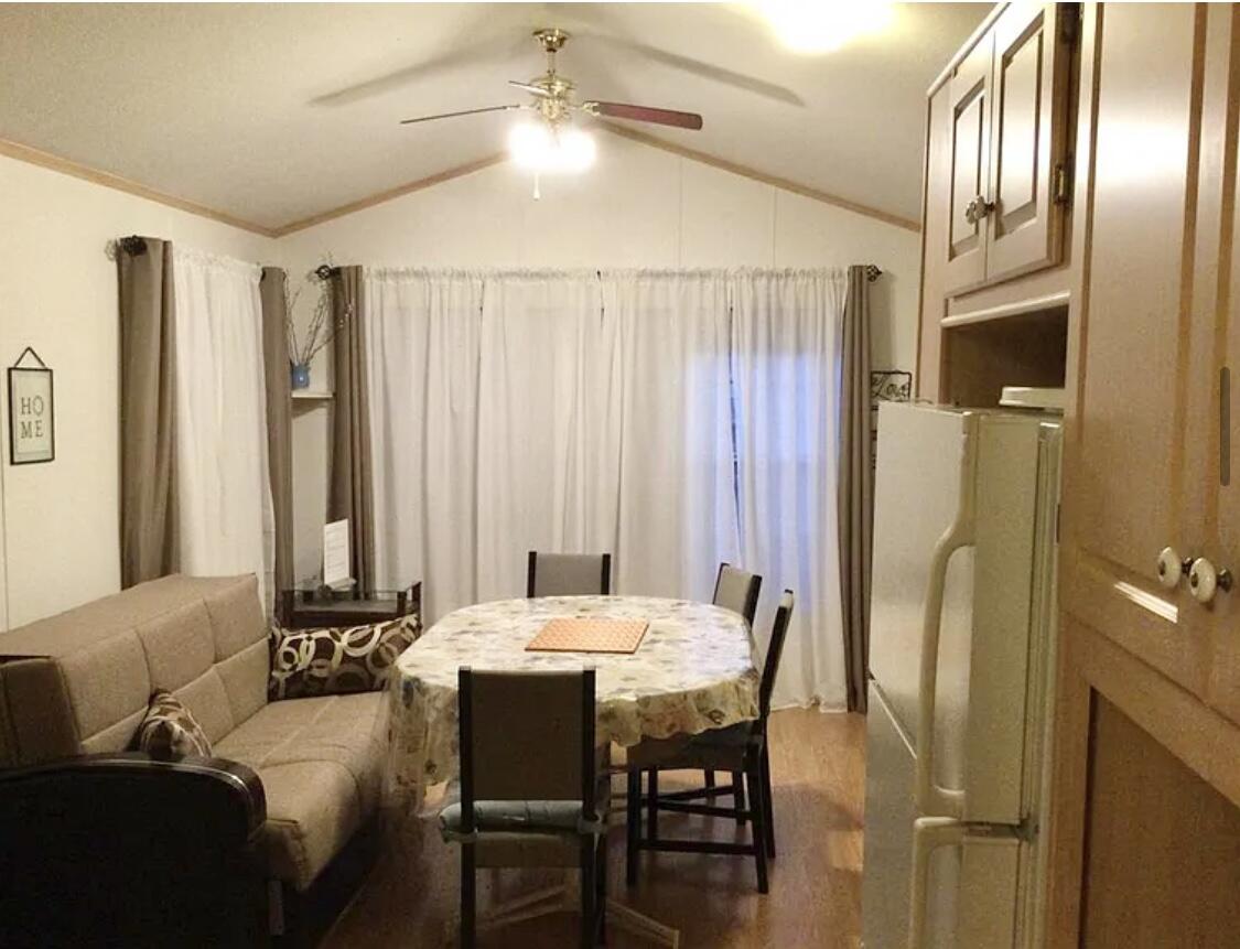 74711 Dillon Road Desert Hot Springs, CA 92241 - Photo 4 of 41 a living room with furniture and a chandelier