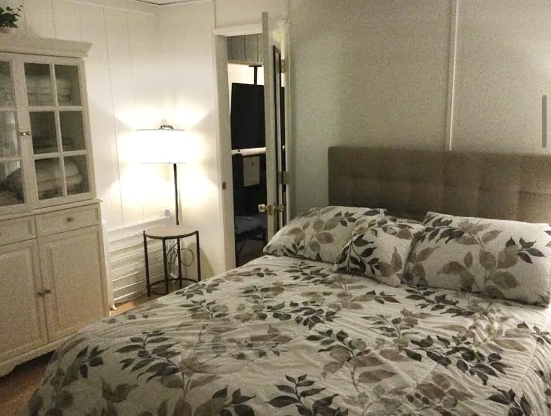 74711 Dillon Road Desert Hot Springs, CA 92241 - Photo 7 of 41 a bedroom with a bed and a lamp on table