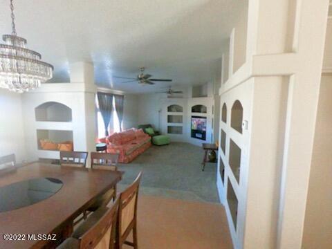 13643 East Bright Sky Loop Vail, AZ 85641 - Photo 8 of 22 a living room with furniture a fireplace and a large window