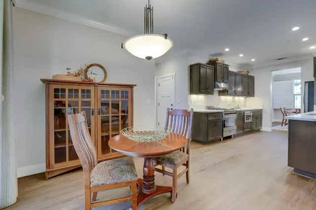 a view of a dining room with furniture and wooden floor
