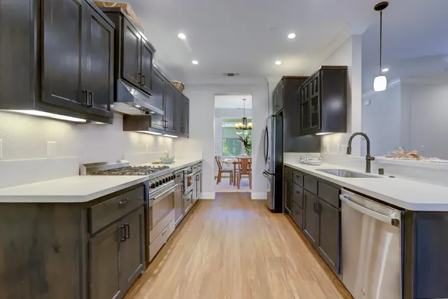 a stove top oven sitting inside of a kitchen