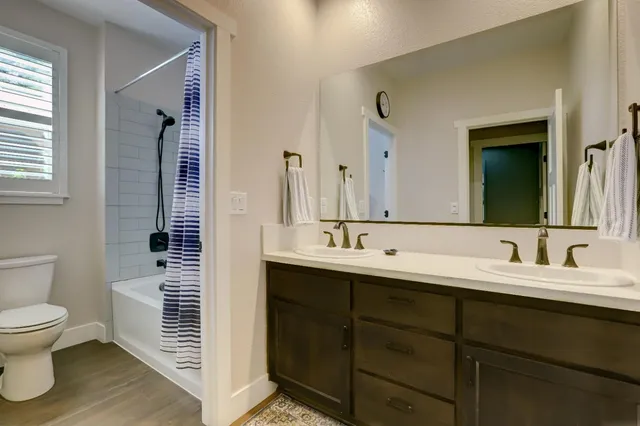 a white bath tub sitting next to a shower