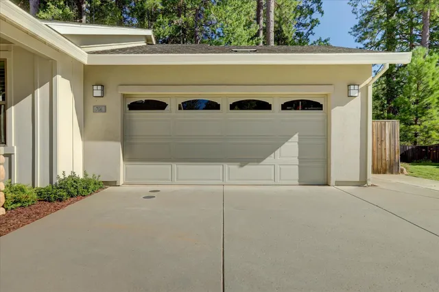 an aerial view of a house with swimming pool and chairs