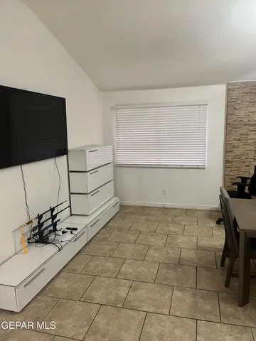 a lobby with furniture and flat screen tv