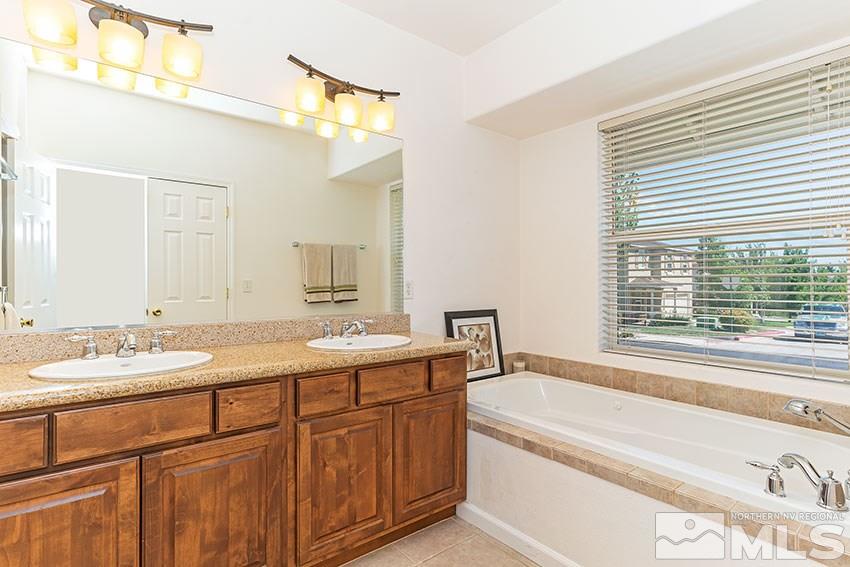 2895 Bryan Street Reno, NV 89503 - Photo 11 of 17 a bathroom with a granite countertop sink and a bathtub