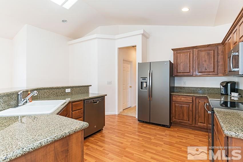 2895 Bryan Street Reno, NV 89503 - Photo 9 of 17 a kitchen with stainless steel appliances granite countertop a sink stove and refrigerator