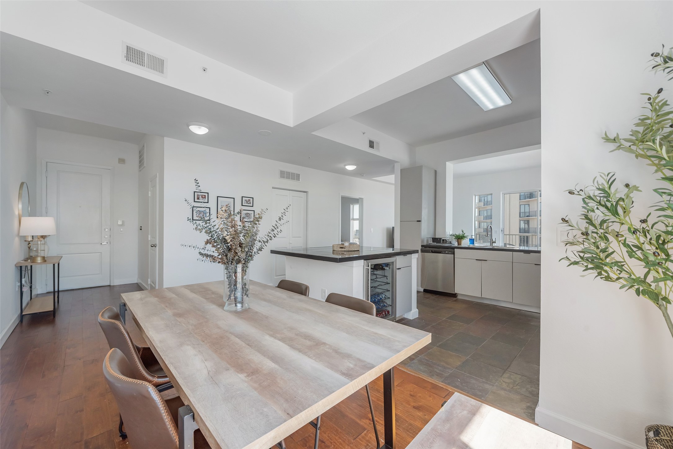 3505 Sage Road, Unit 2210 Houston, TX 77056 - Photo 3 of 40 The open kitchen features a large island and ample counter space for both meal prep and entertaining, flowing seamlessly into the adjoining dining room.