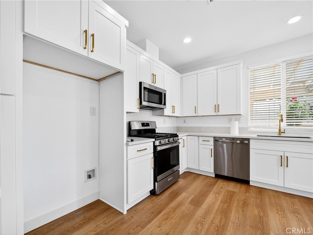 1436 Riviera Avenue Banning, CA 92220 - Photo 7 of 43 a kitchen with a stove top oven sink and cabinets