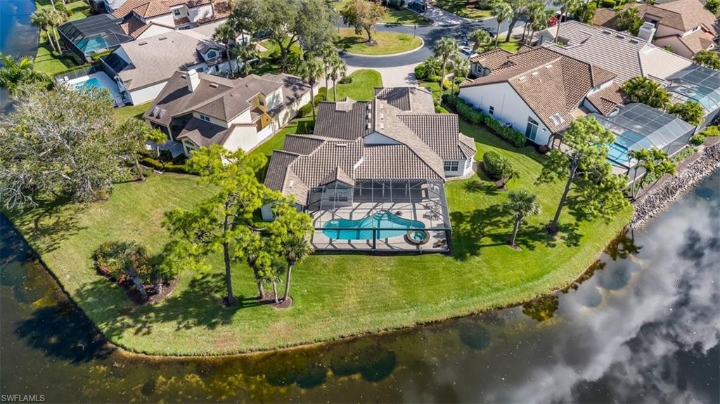 an aerial view of a house with swimming pool and ocean view