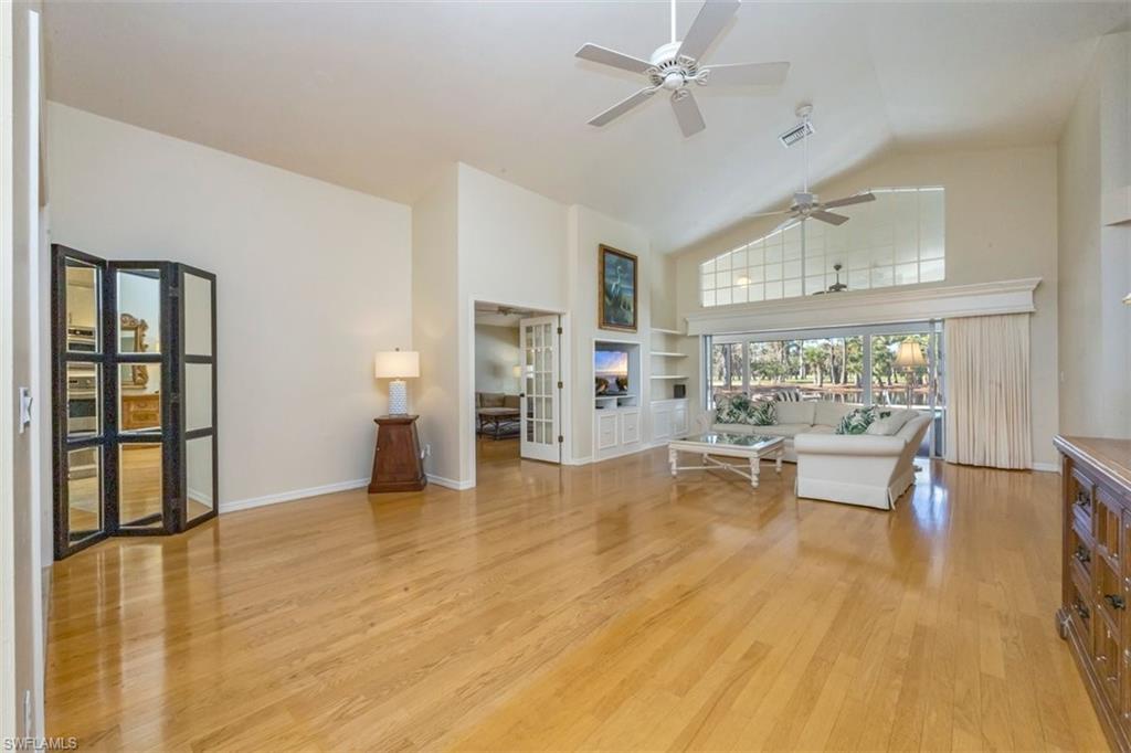 25 Grey Wing Point Naples, FL 34113 - Photo 11 of 25 a living room with furniture and a large window