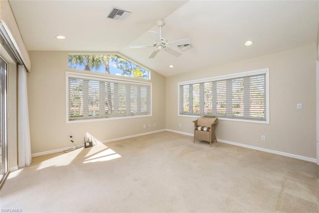 25 Grey Wing Point Naples, FL 34113 - Photo 18 of 25 an empty room with windows and ceiling fan