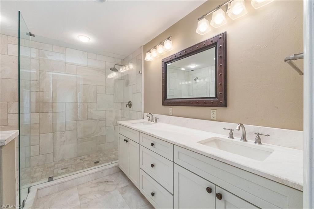 25 Grey Wing Point Naples, FL 34113 - Photo 19 of 25 a bathroom with a double vanity sink mirror and double