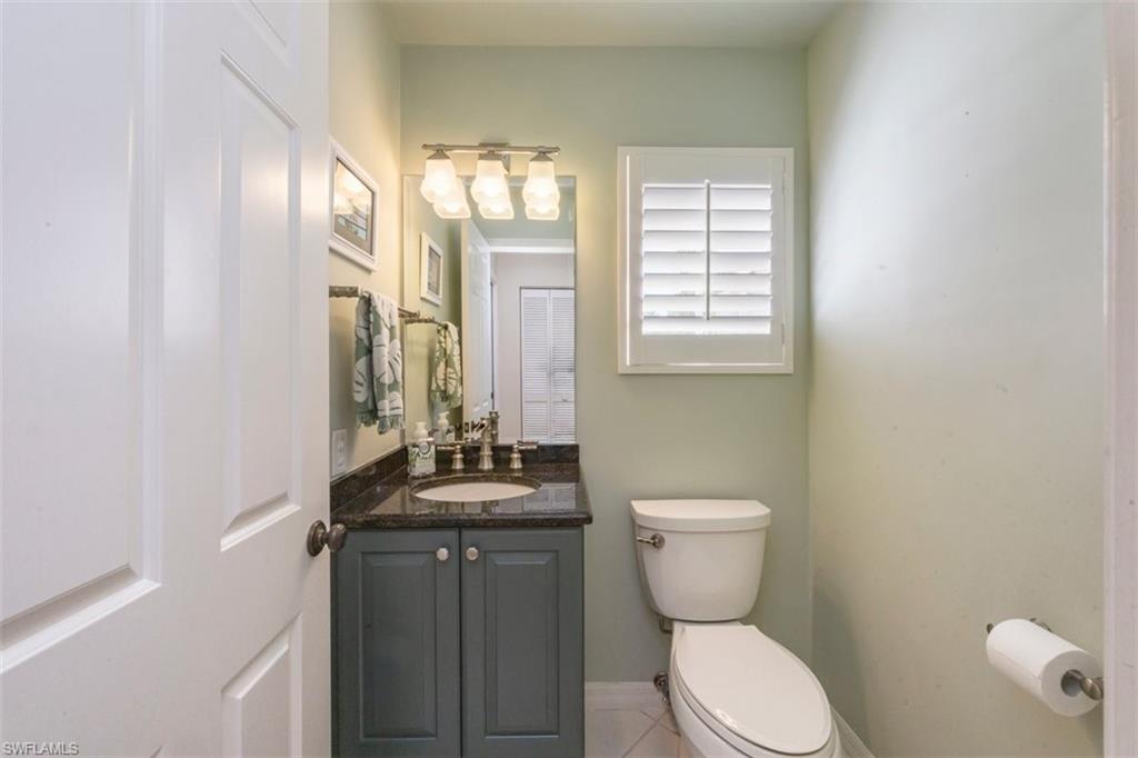 25 Grey Wing Point Naples, FL 34113 - Photo 20 of 25 a bathroom with a toilet a sink and a mirror