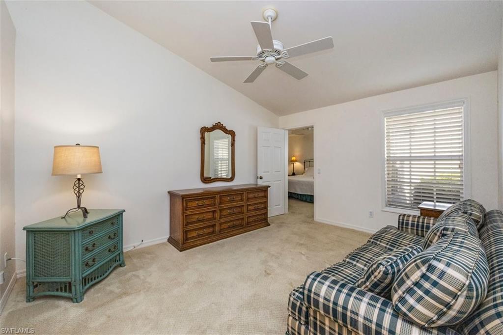 25 Grey Wing Point Naples, FL 34113 - Photo 23 of 25 a bed room with a bed and a chandelier