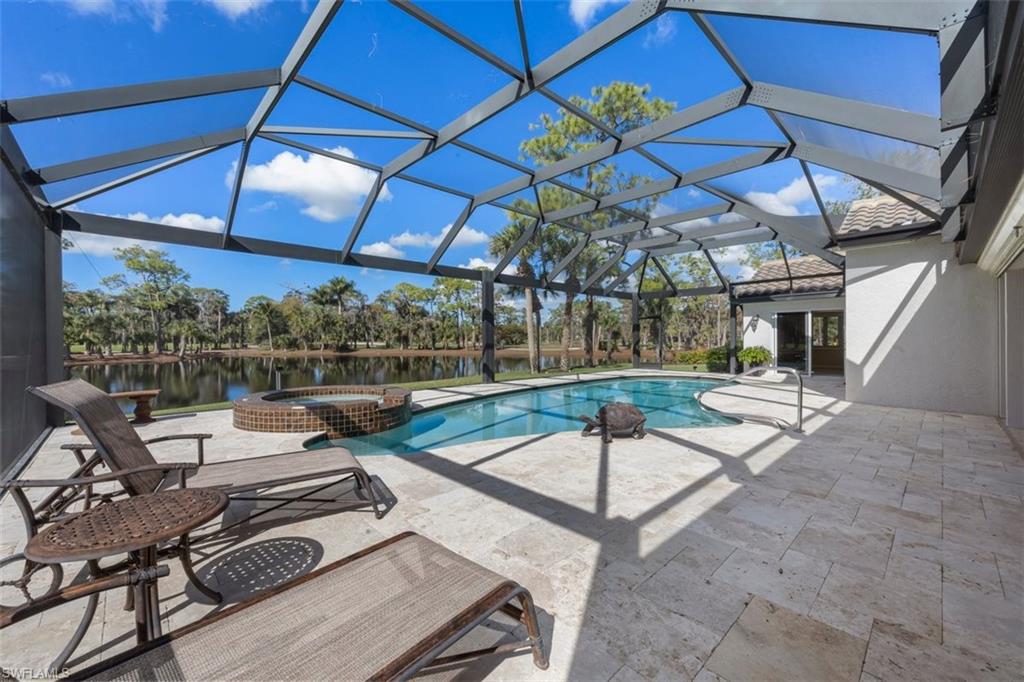 25 Grey Wing Point Naples, FL 34113 - Photo 5 of 25 a view of a patio with a table and chairs under an umbrella