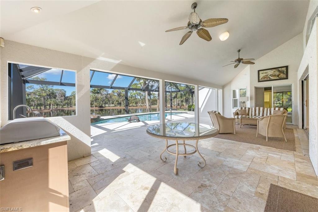 25 Grey Wing Point Naples, FL 34113 - Photo 8 of 25 a living room with furniture and a floor to ceiling window