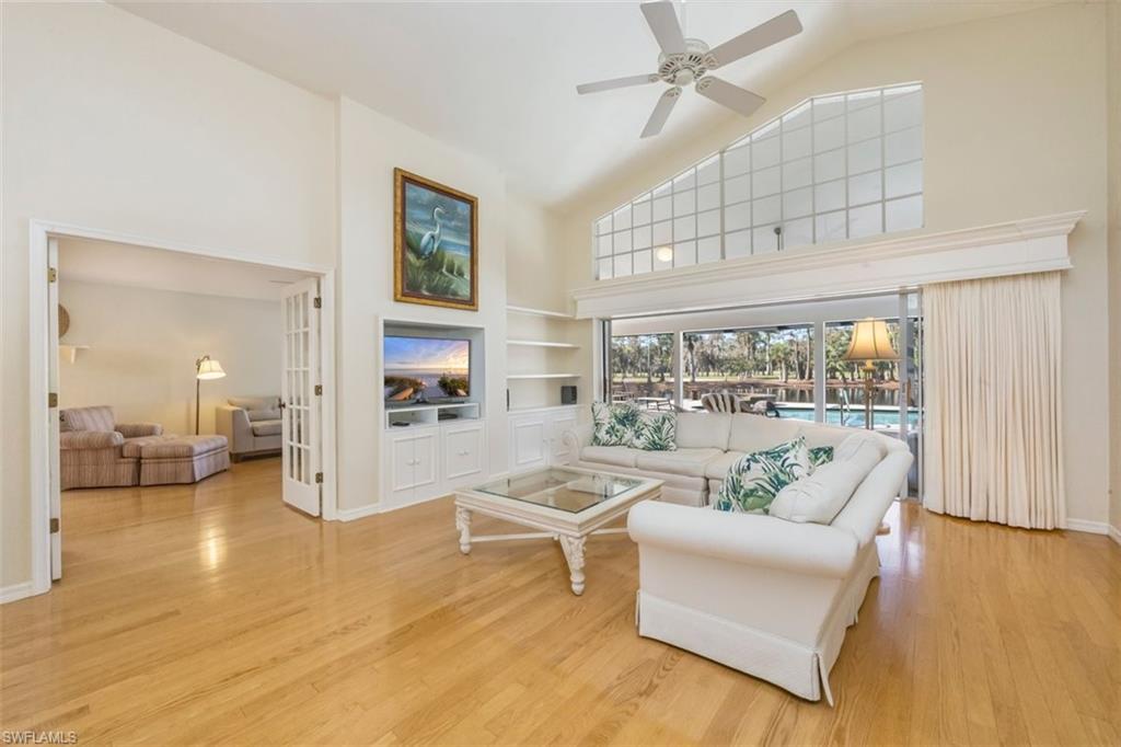 25 Grey Wing Point Naples, FL 34113 - Photo 10 of 25 a living room with furniture and a large window