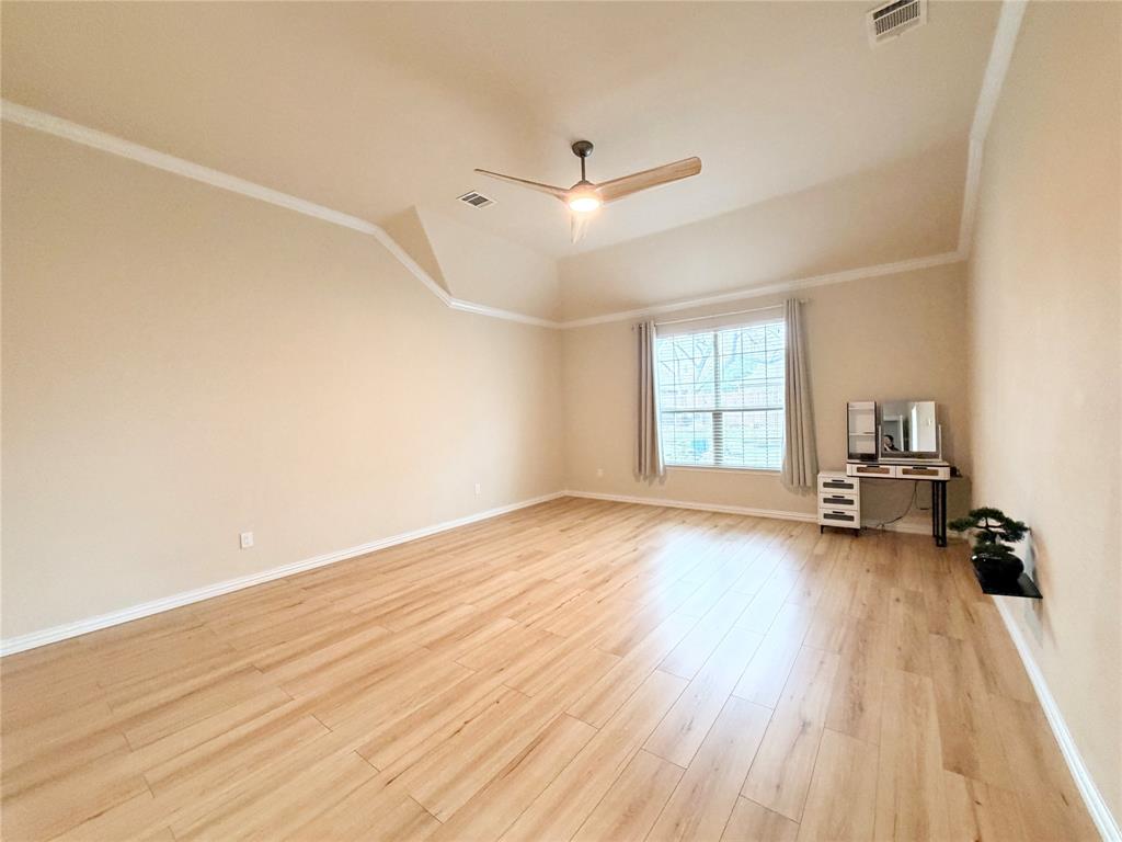 501 Elwood Road Irving, TX 75061 - Photo 13 of 30 a view of empty room with wooden floor and fan