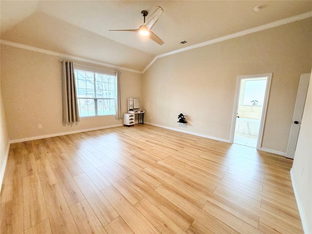501 Elwood Road Irving, TX 75061 - Photo 14 of 30 an empty room with wooden floor and windows