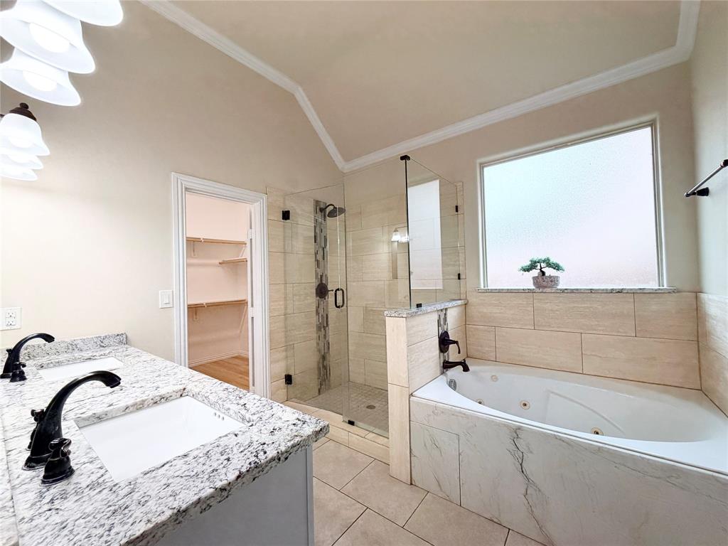 501 Elwood Road Irving, TX 75061 - Photo 15 of 30 a bathroom with a granite countertop sink a mirror and a bathtub