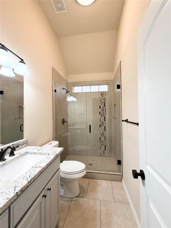 501 Elwood Road Irving, TX 75061 - Photo 22 of 30 a bathroom with a granite countertop sink a toilet and shower