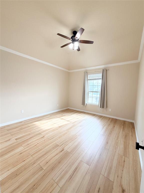 501 Elwood Road Irving, TX 75061 - Photo 24 of 30 an empty room with wooden floor fan and windows