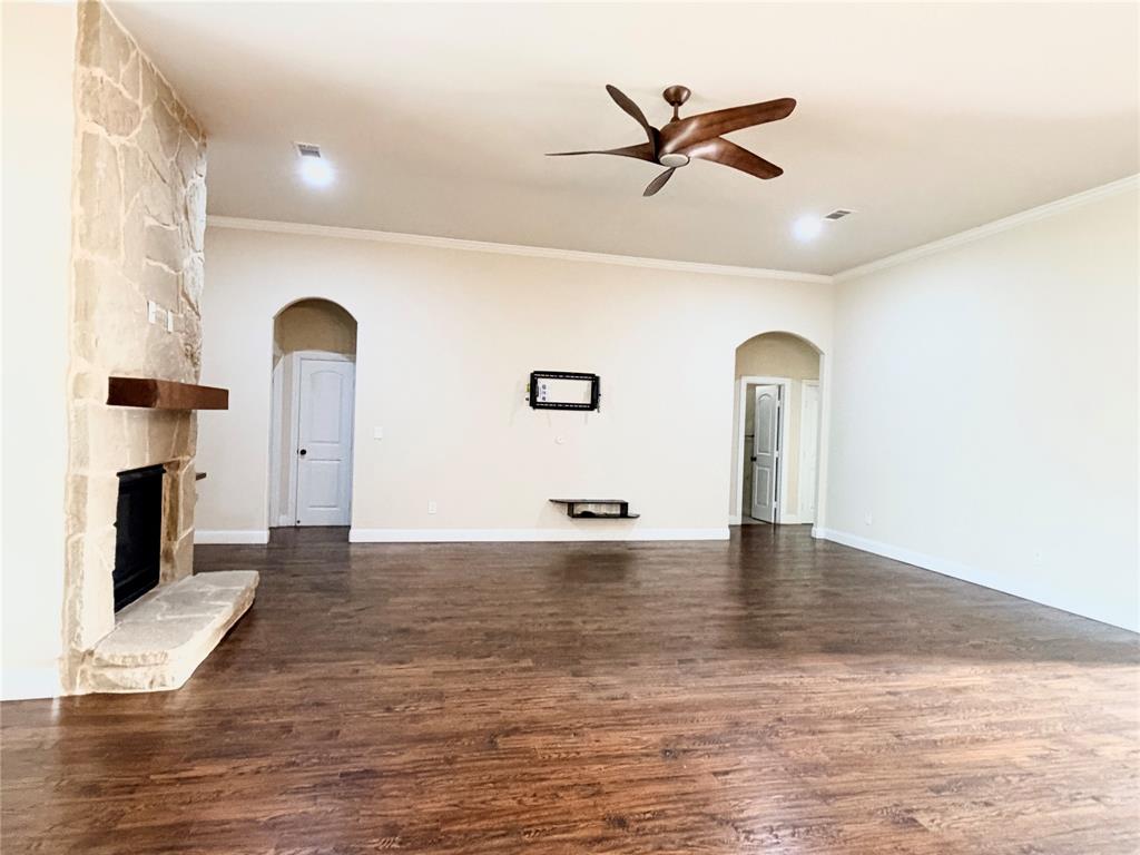 501 Elwood Road Irving, TX 75061 - Photo 4 of 30 a view of a livingroom with a fireplace a ceiling fan and wooden floor